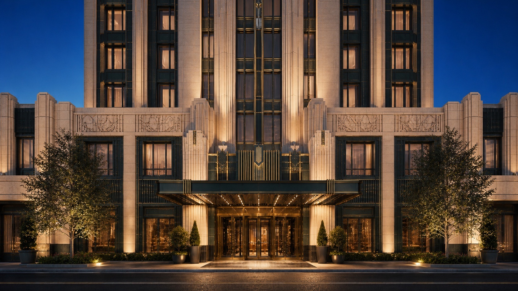 Symmetrical Art Deco hotel facade with fluted stone piers and a bronze canopy at blue hour
